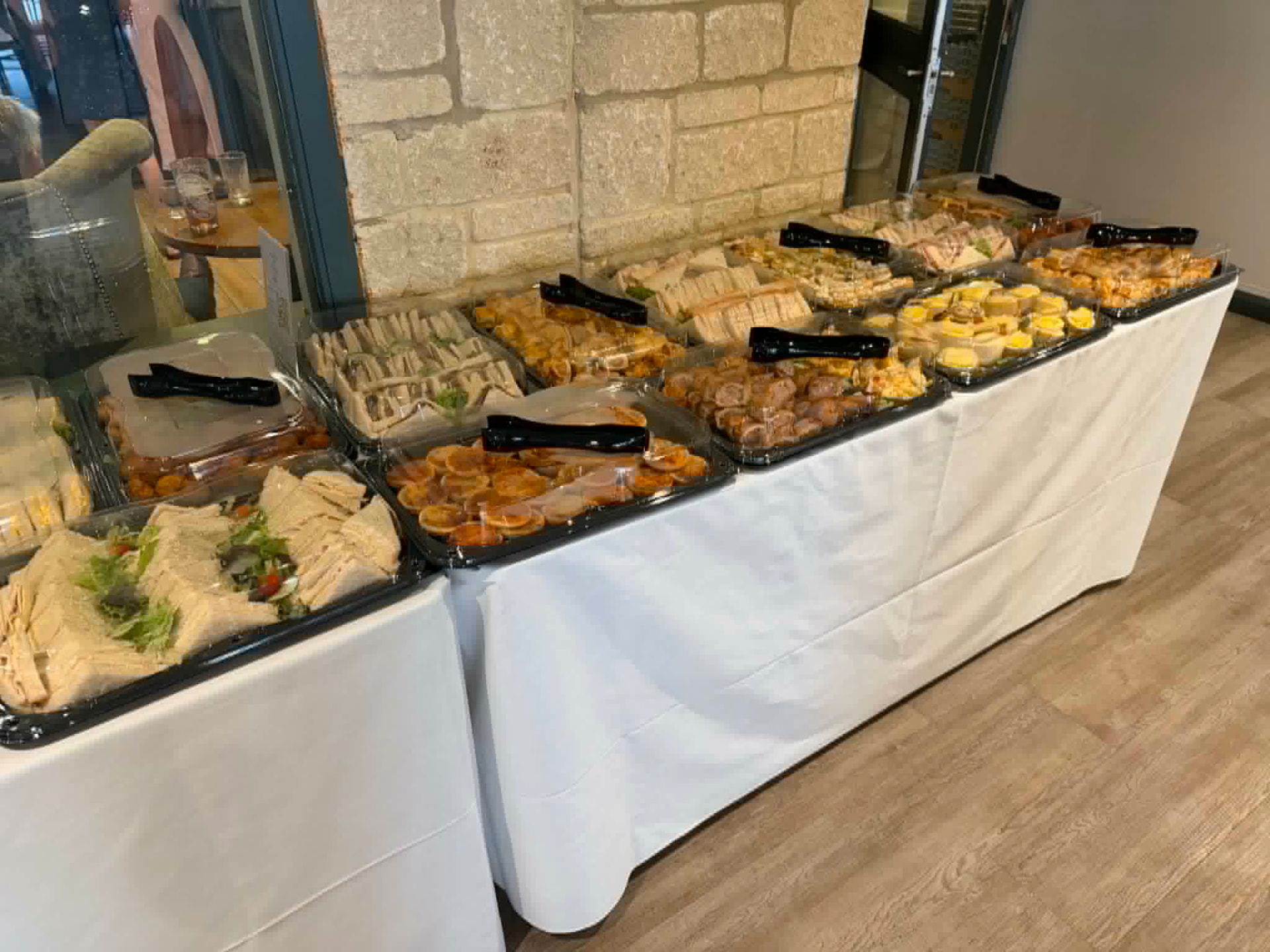 Long buffet table of sandwiches, savouries and hot bites