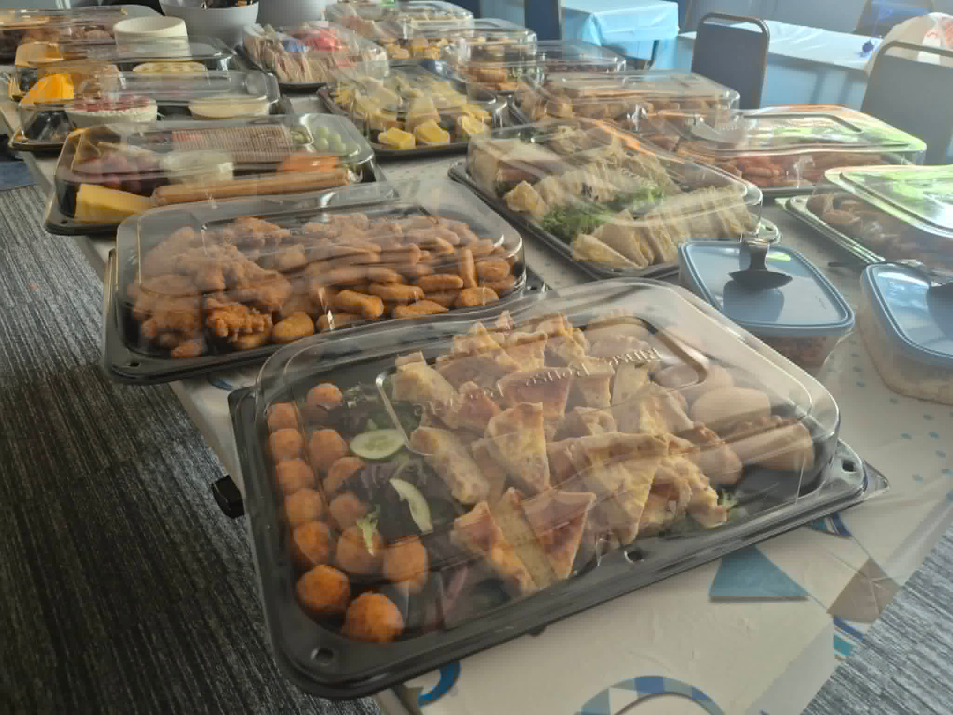 Buffet tables laid with sandwich, pastry and savoury platters