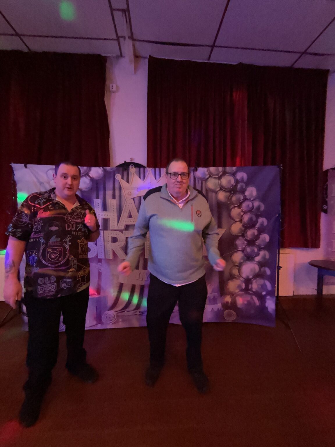 Guest posing in front of the balloon backdrop