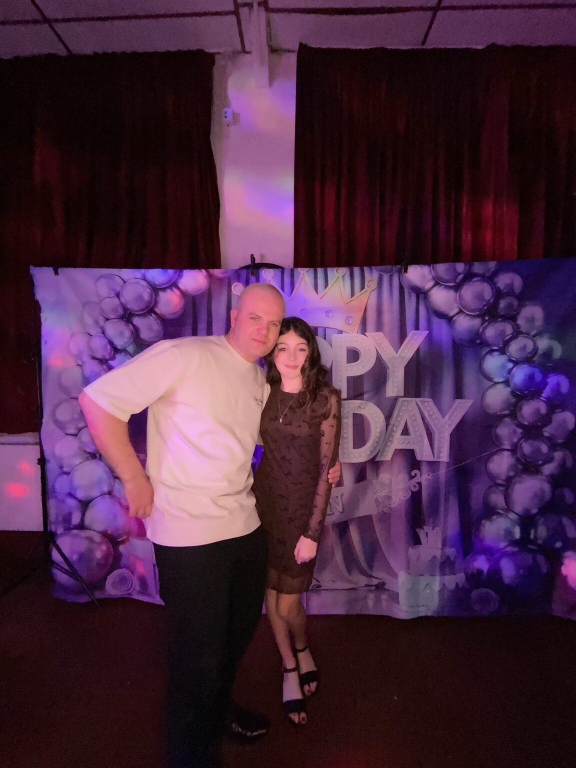 Couple at the photo booth backdrop